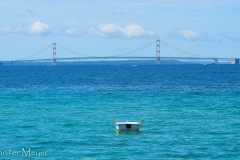 Rowboat anchored offshore.