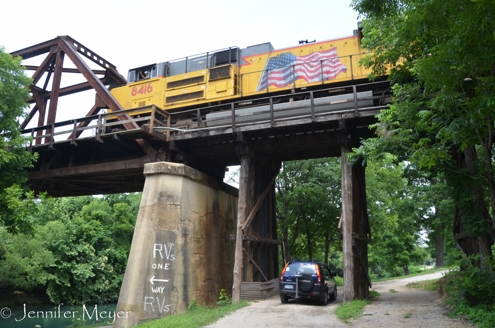 The engineer waves at me while Kate drives under the trestle.