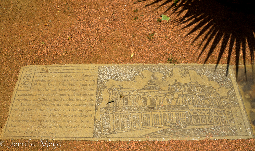 Sidewalk memorial to an elegant saloon once on this plaza.