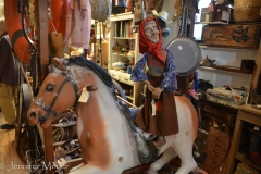 Witch puppet on a horse.